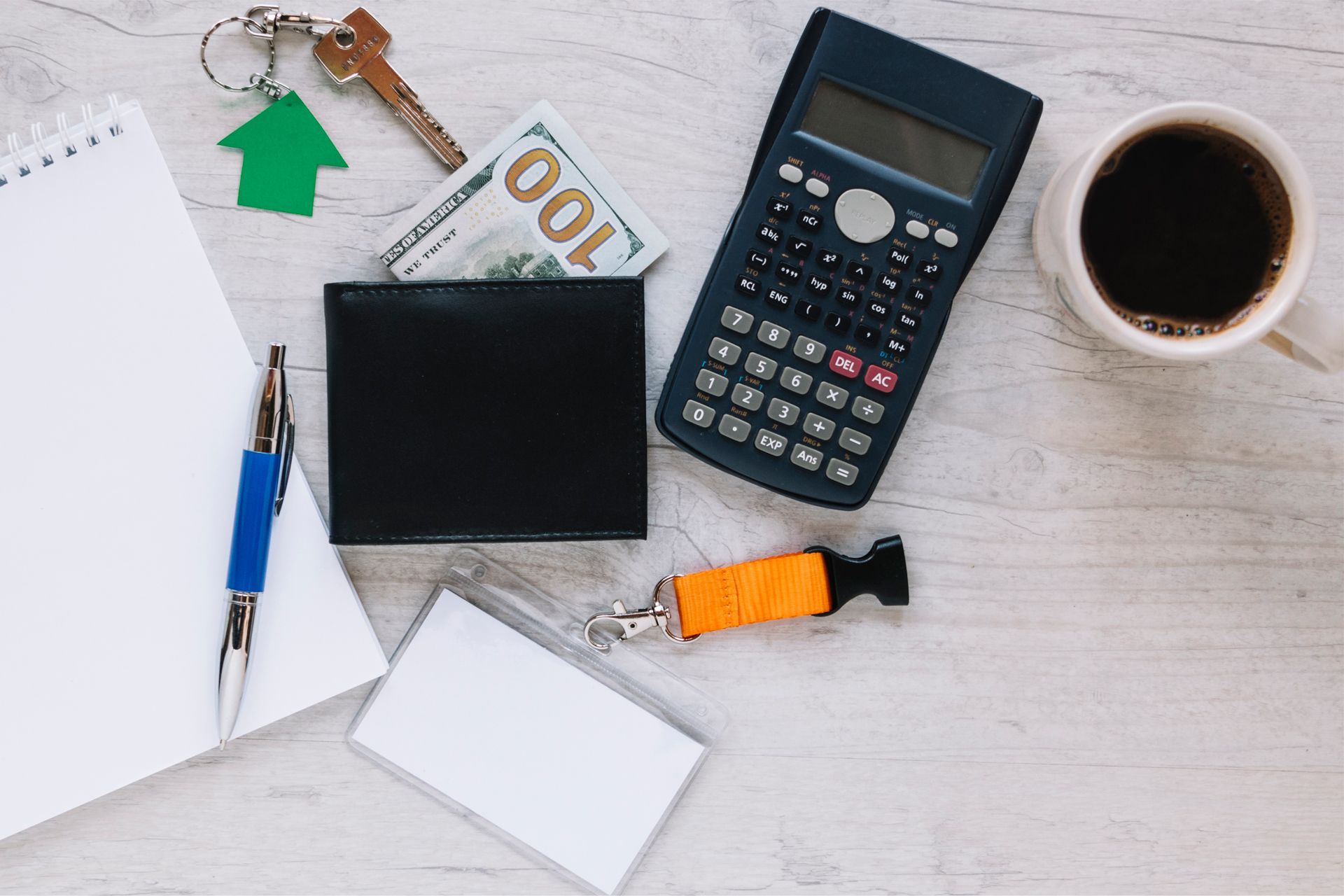 Overhead View of Notepad, Pen, Keys, Money, Wallet, Calculator, Coffee and Name Tag Overhead View of Notepad, Pen, Keys, Money, Wallet, Calculator, Coffee and Name Tag