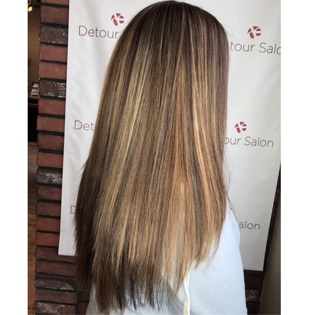 Long, straight hair with blonde highlights against a white backdrop.