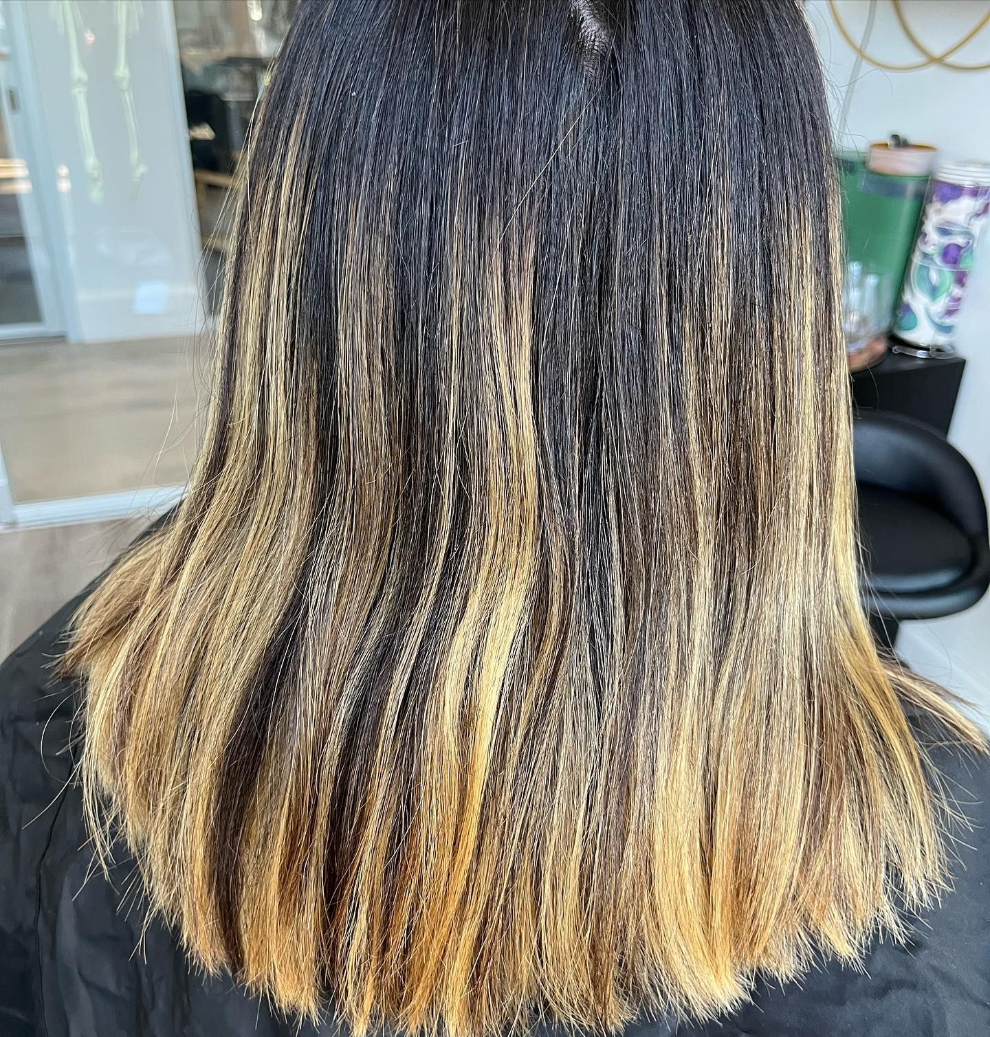 Hair with dark roots, transitioning to blonde at the ends.