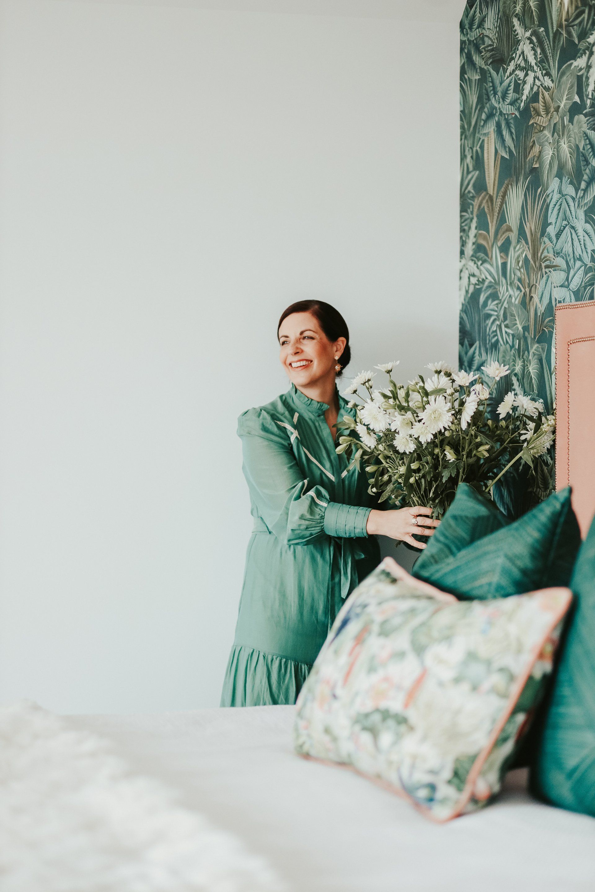 Interior Designer Styling Flowers In Bedroom