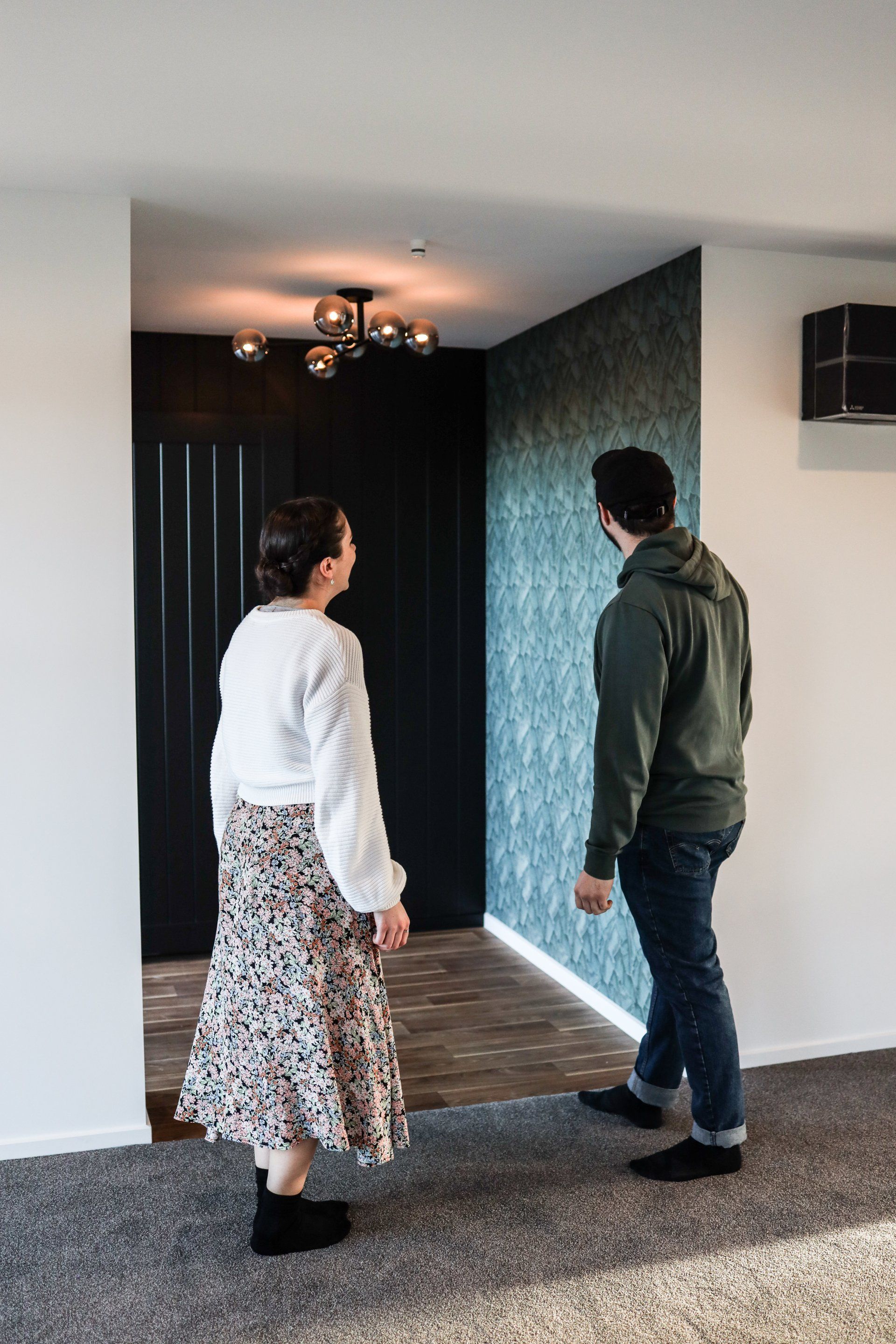 A man and a woman are standing next to each other in a room.