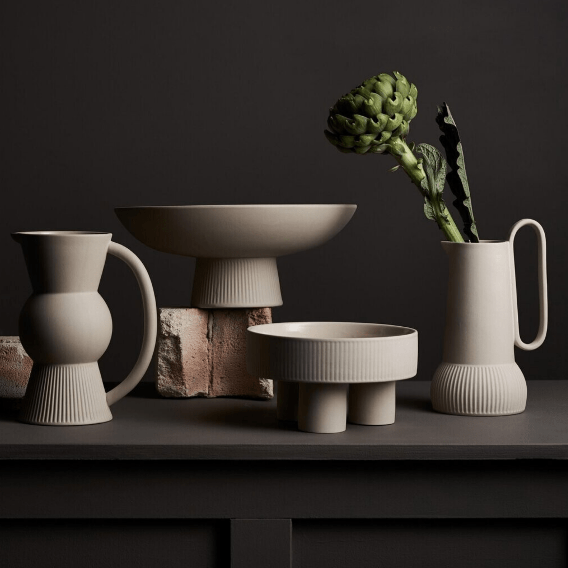 A vase with a plant in it sits on a table
