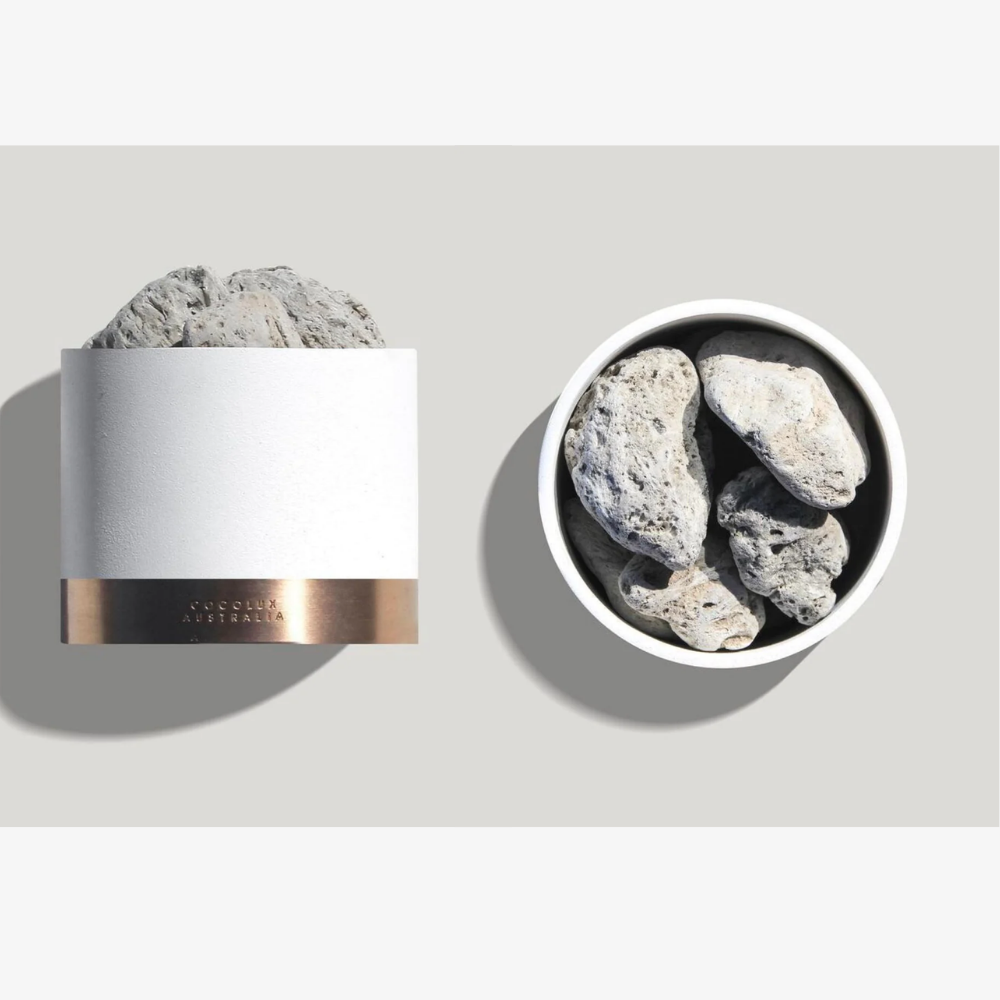 A white container filled with rocks next to a bowl filled with rocks