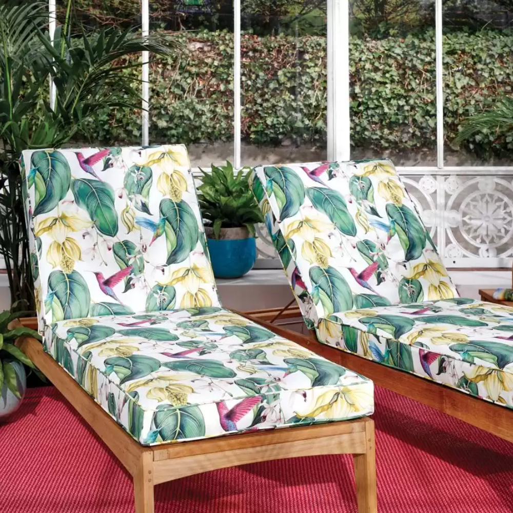 Two lounge chairs with a tropical print on them