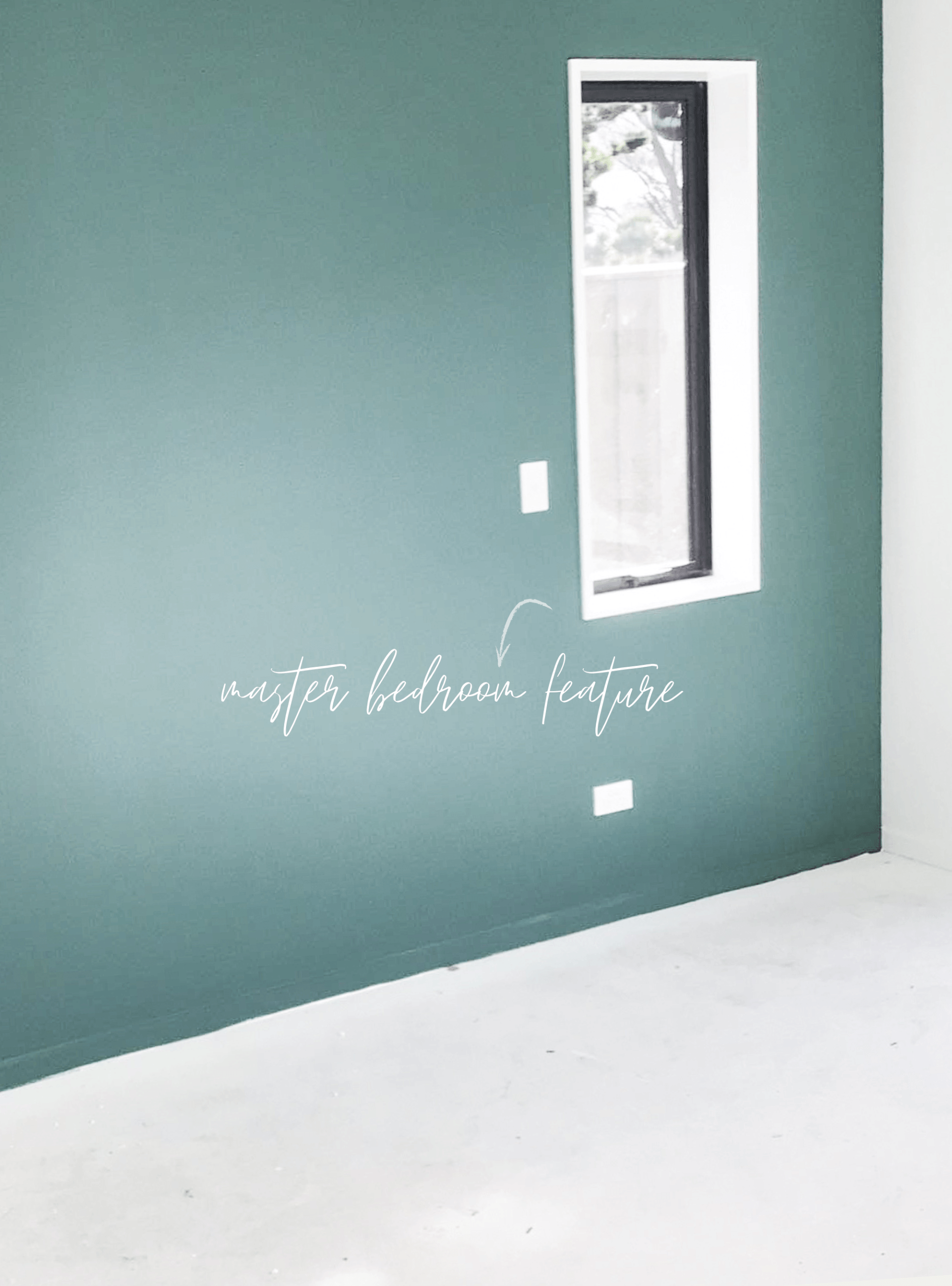 A room with a green wall and a window