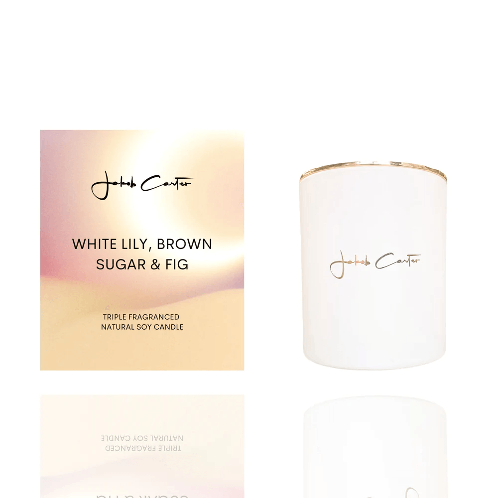 A white lily , brown sugar and fig candle with a box.