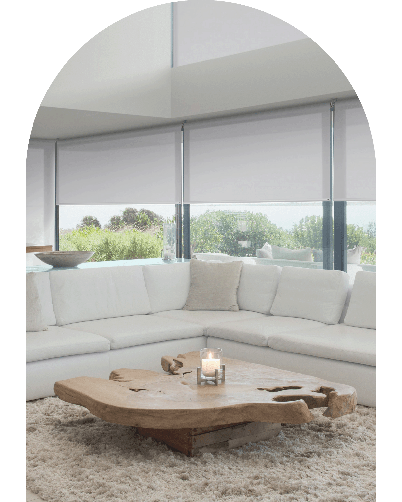A living room with a white sectional couch and a wooden coffee table.