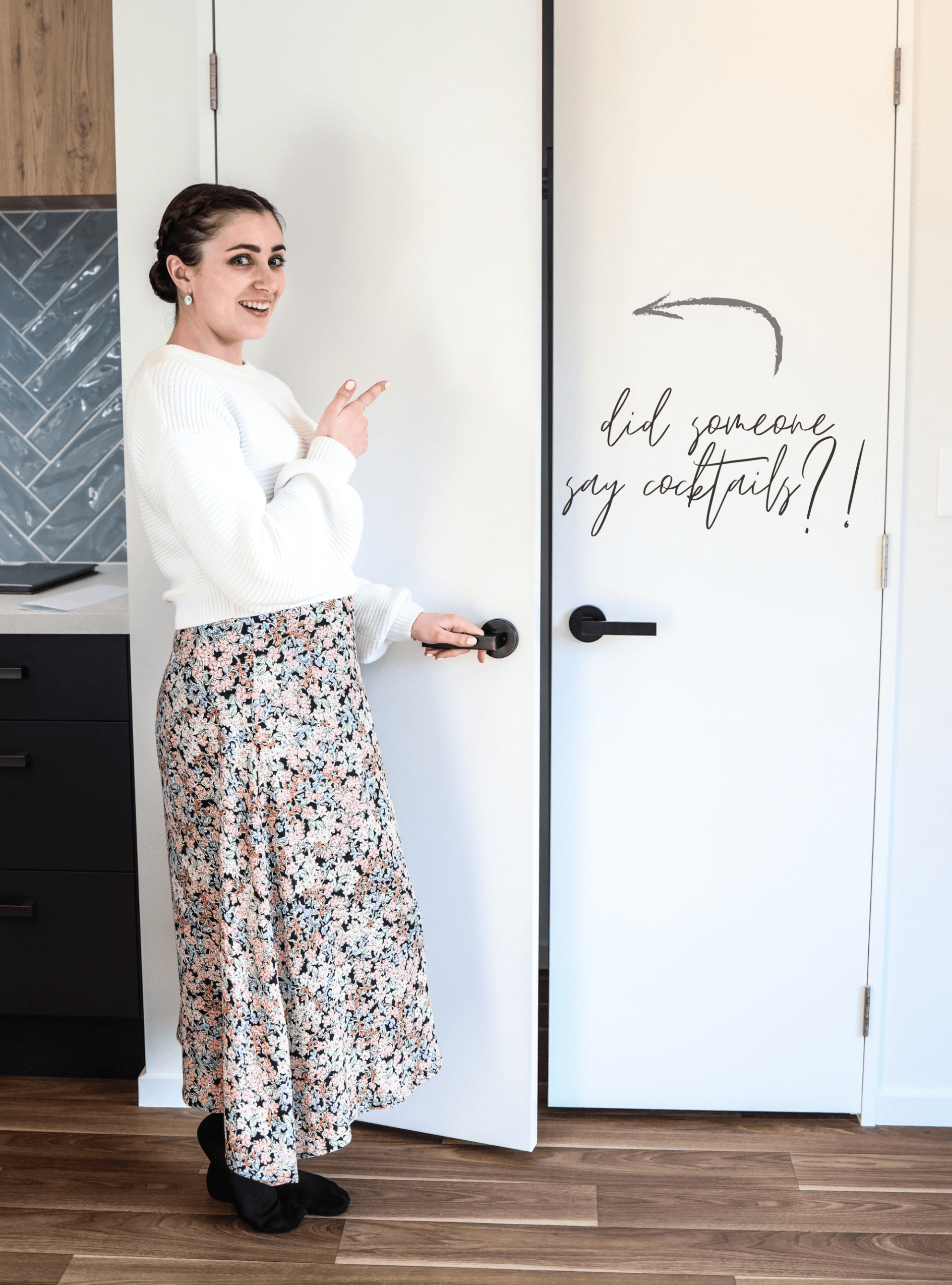 A woman is standing in front of a white door.