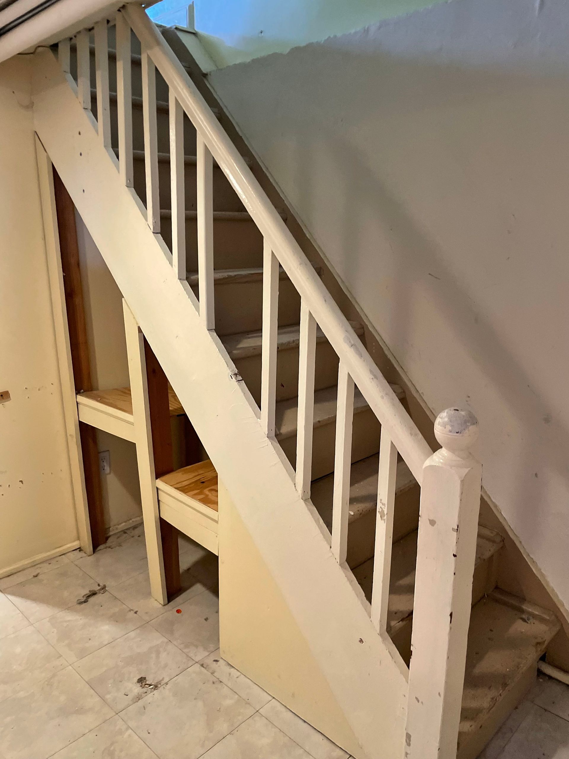 A staircase in a room with a white railing