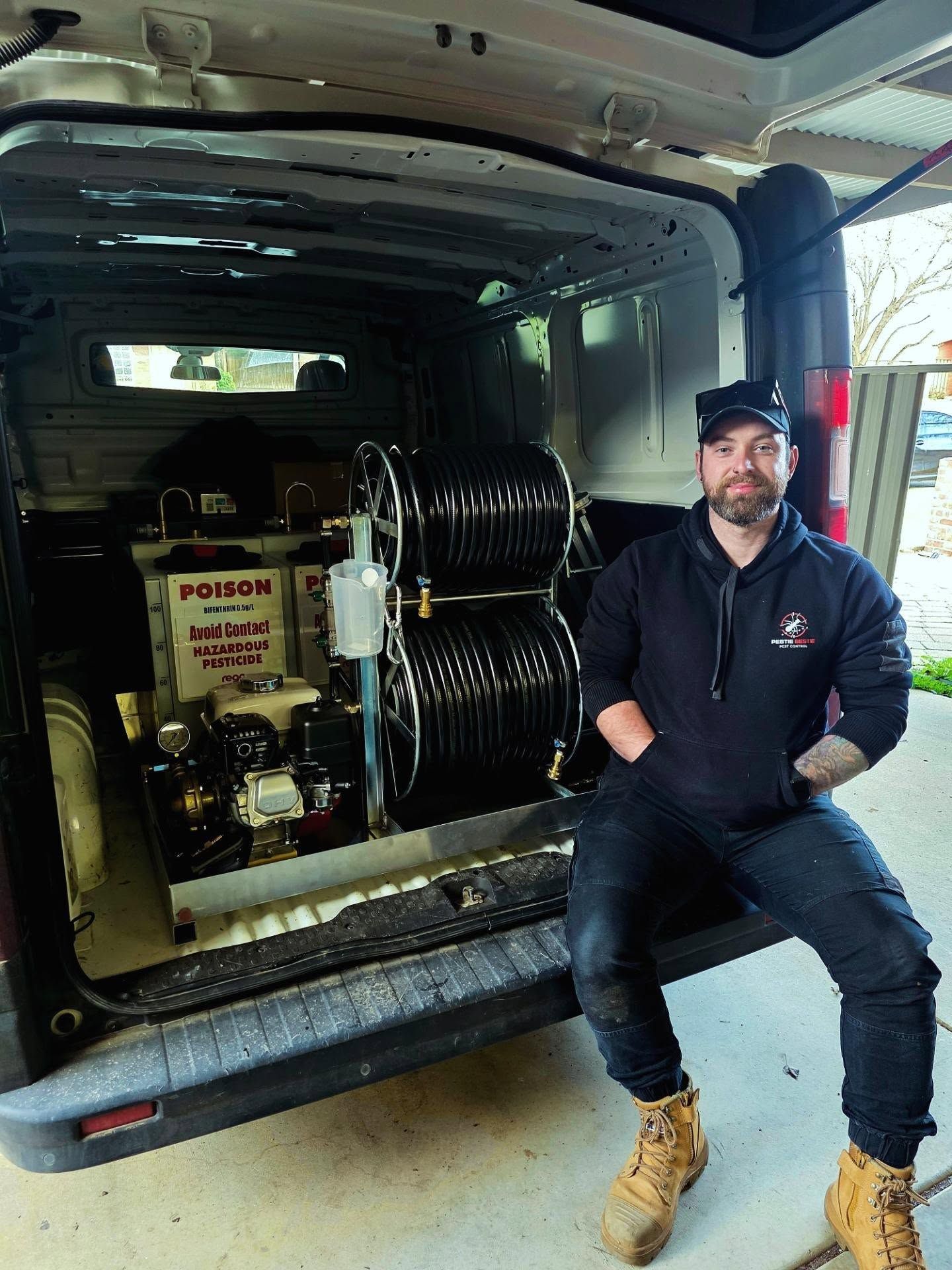 Technician Sitting in a Van Beside Industrial Hoses and Equipment — Pestie Bestie Pest Control In Shepparton, VIC