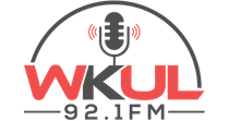 Logo for WKUL 92.1 FM radio station with a microphone inside an arch. The text 