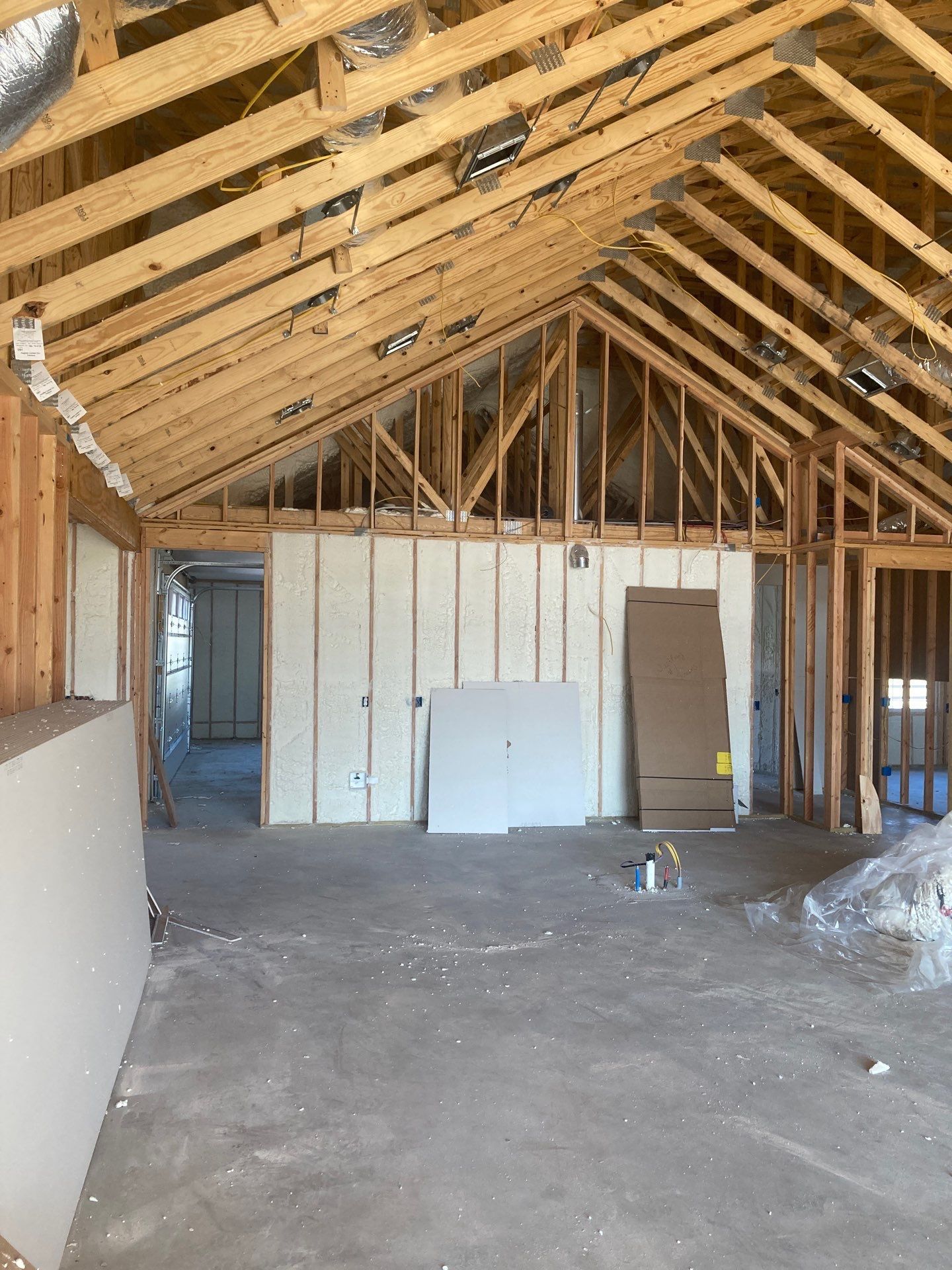 The inside of a building under construction with a wooden roof.