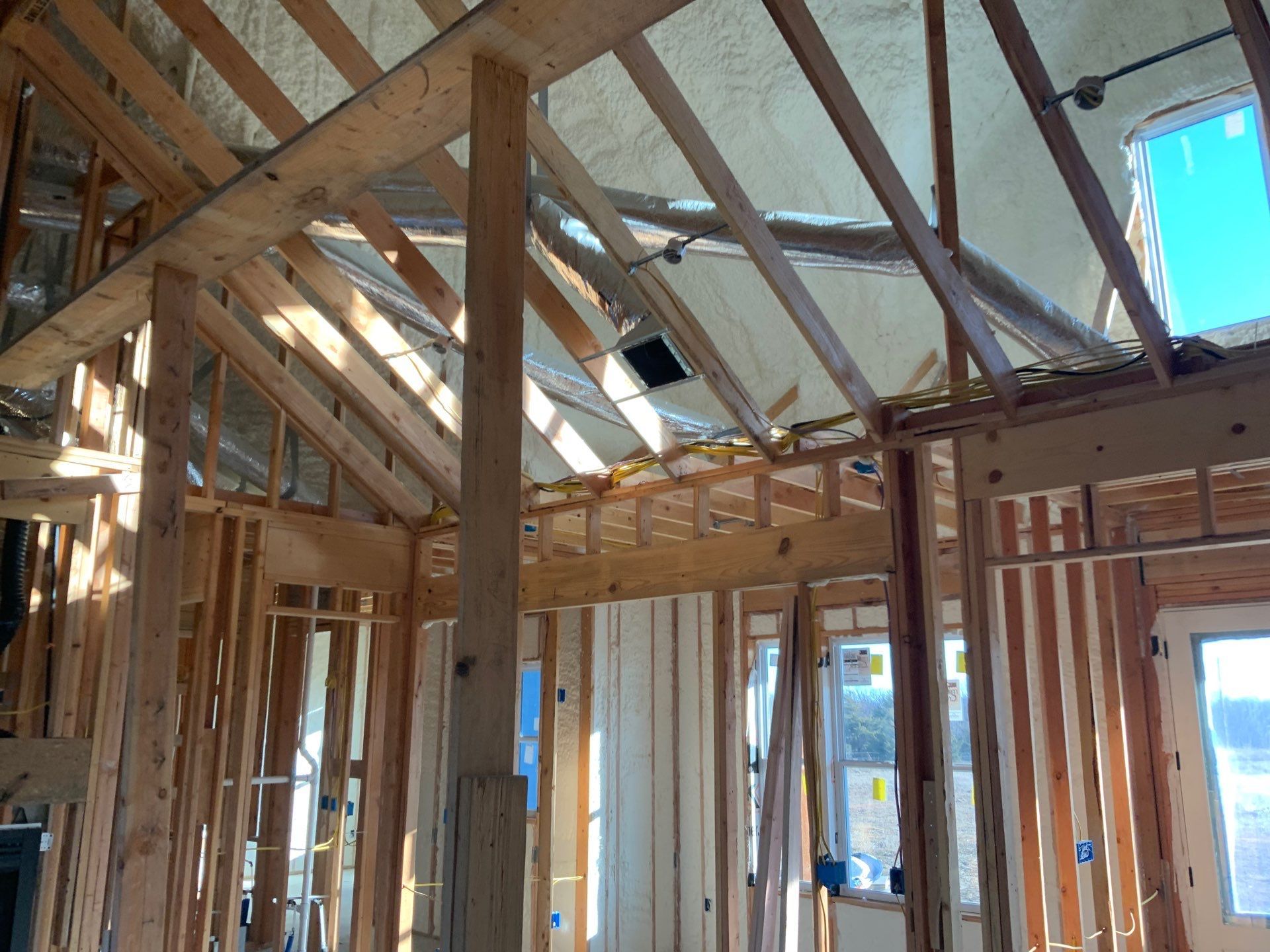 The inside of a house under construction with a lot of wooden beams.