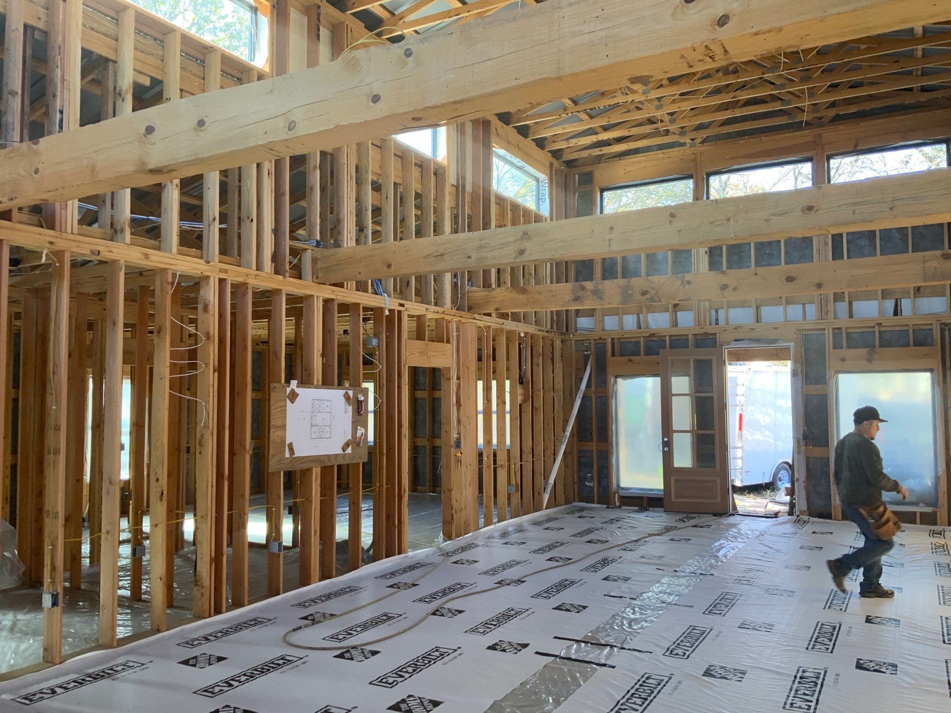 A man is walking through a building under construction.