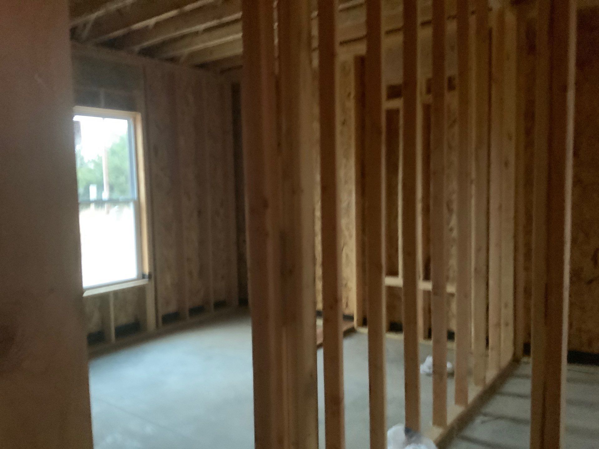 An empty room with wooden walls and a window