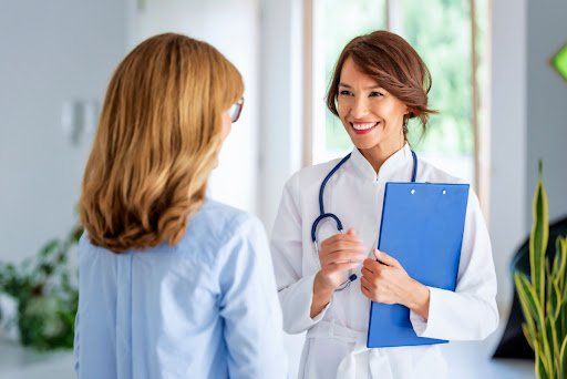 A woman talking to a doctor in an office.