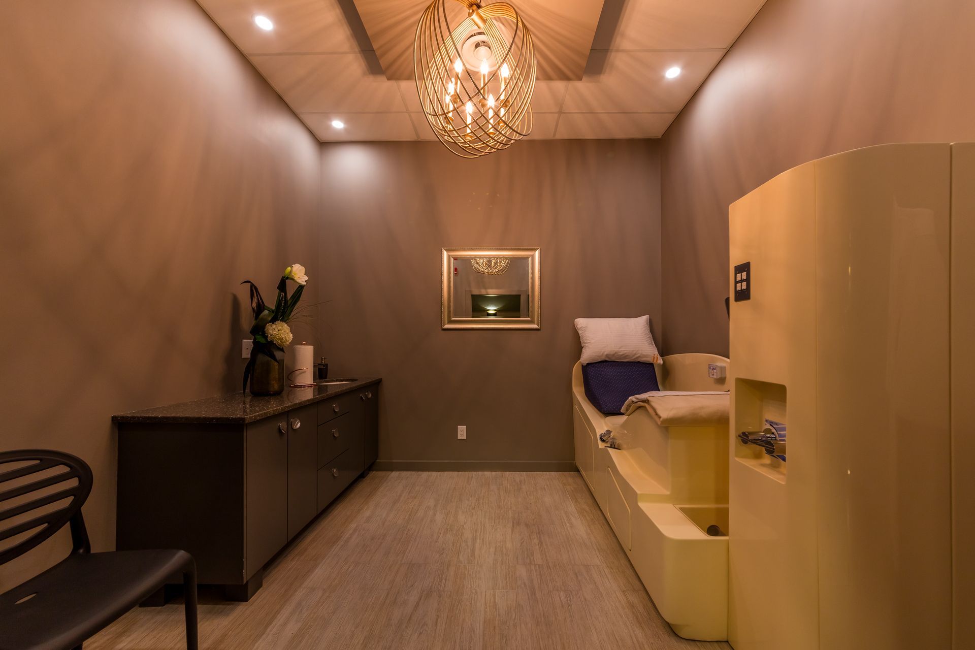 A spa room with millwork and a relaxing chair for performing medical procedure