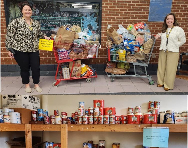 Two women are standing next to a cart full of food.