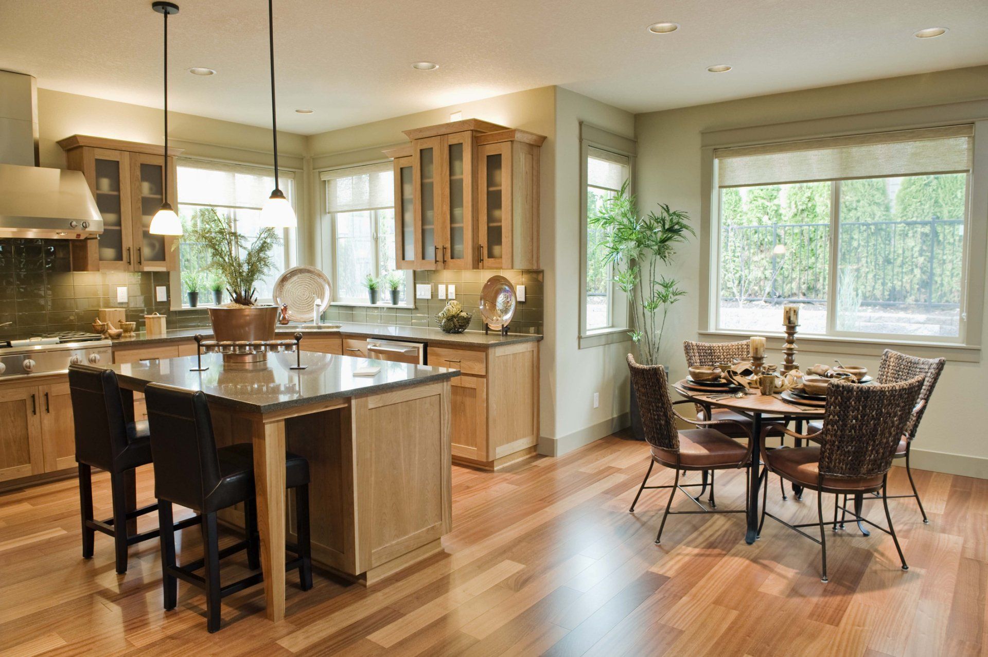 A kitchen and dining room in a house with hardwood floors. A kitchen and dining room in a house with hardwood floors.
