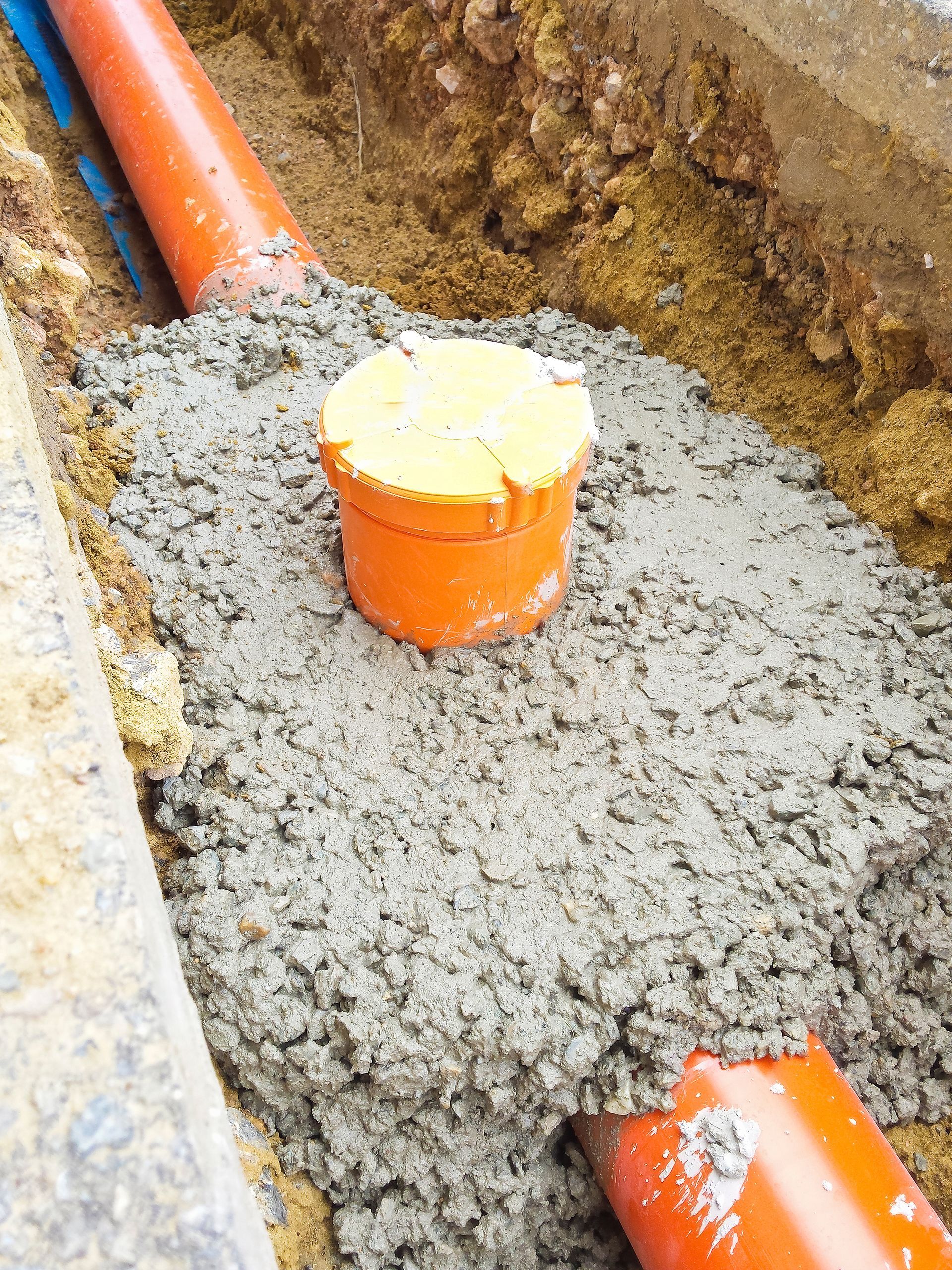 A pipe is sitting on top of a pile of concrete.