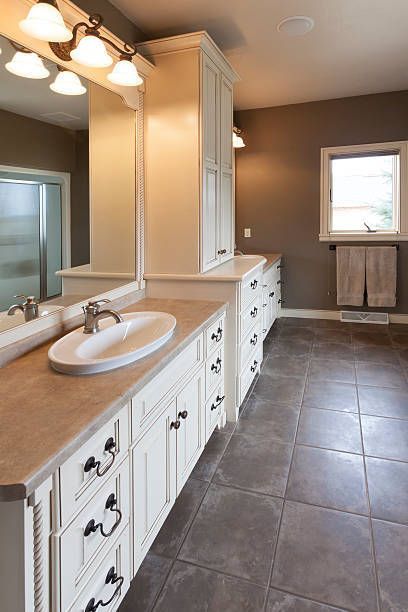 A bathroom with two sinks and a large mirror.