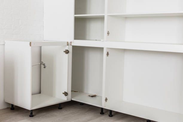 A kitchen cabinet is being built with the door open.
