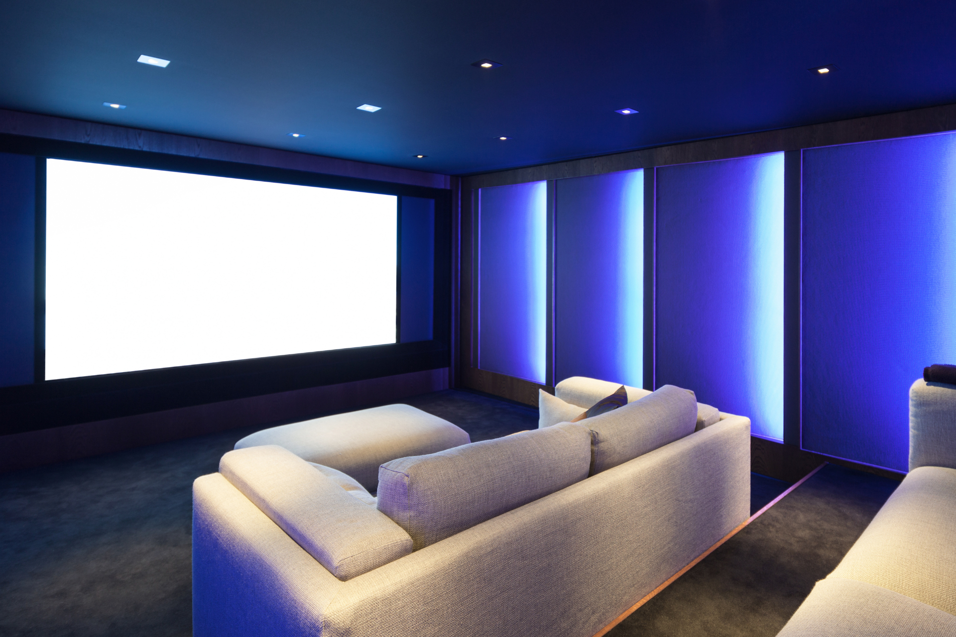 A home theater with a couch and a large screen