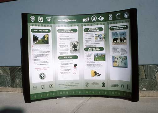 Informational sign about wildlife with green, white, and black design. Features text and images.