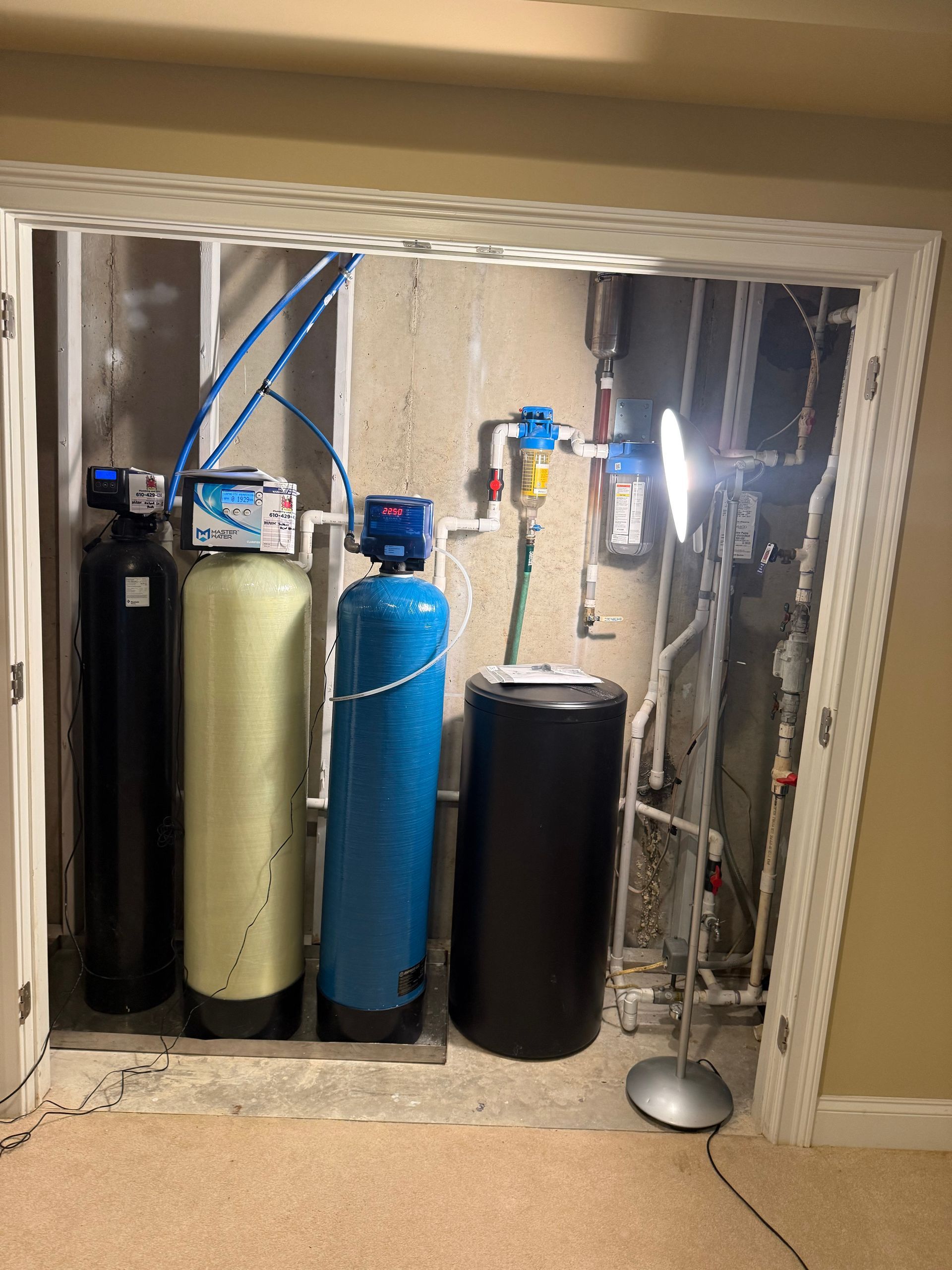 A water treatment system is installed in a basement.