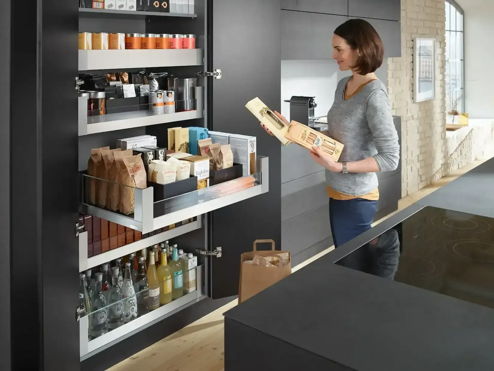 Woman in a grocery store aisle selecting packaged bread from a shelf.
