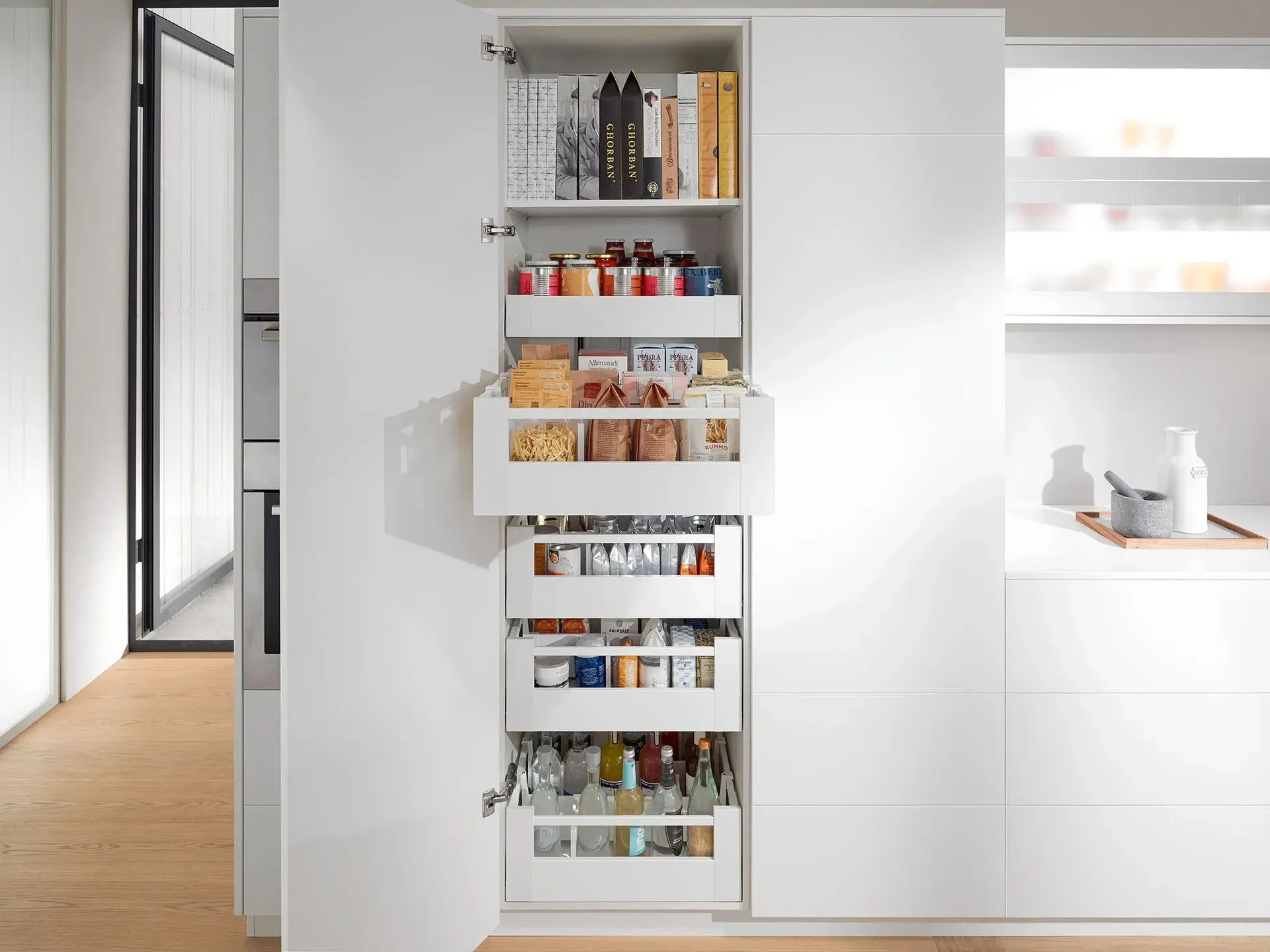 A kitchen with a pantry filled with lots of food.