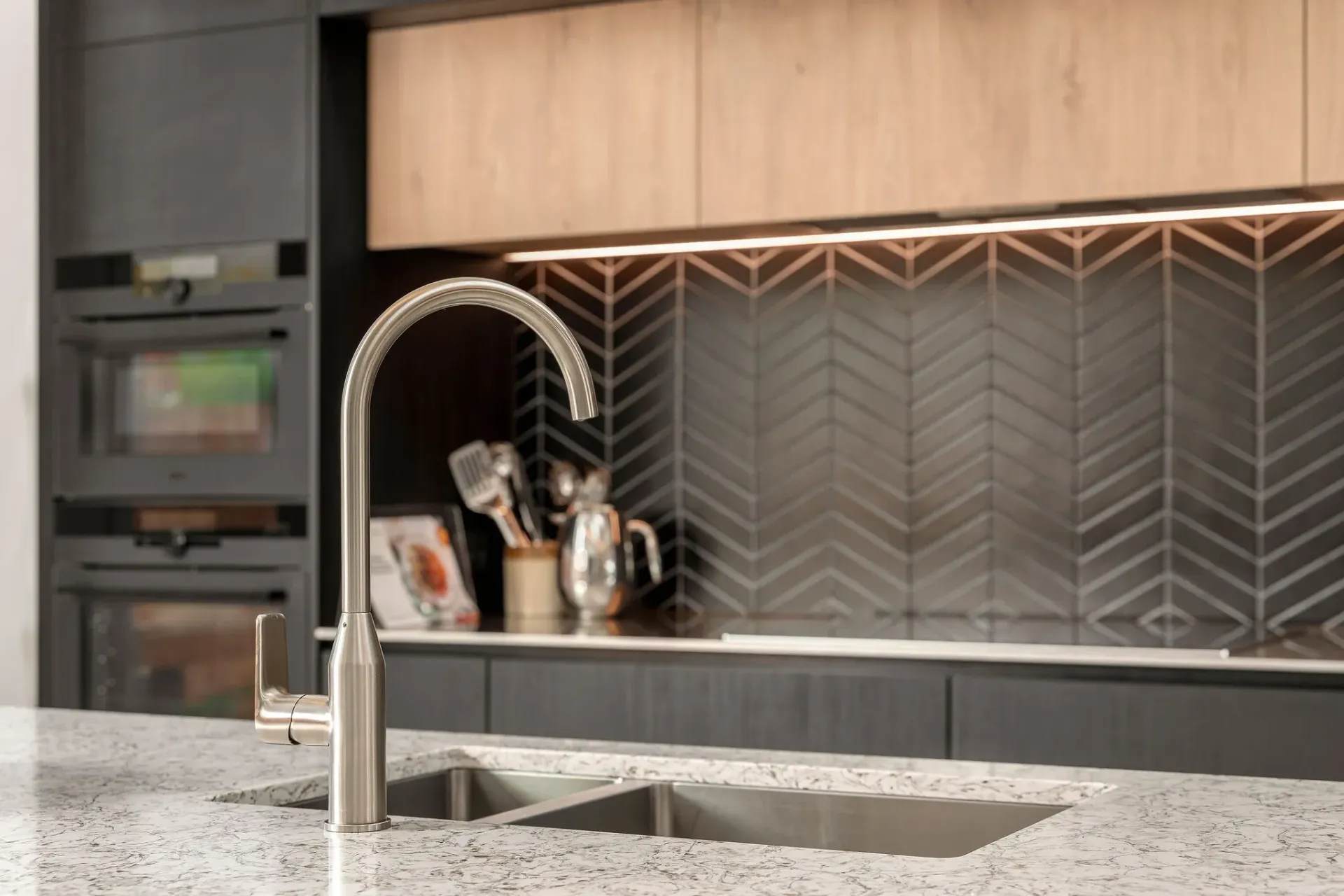 A kitchen with a sink and a faucet on the counter.