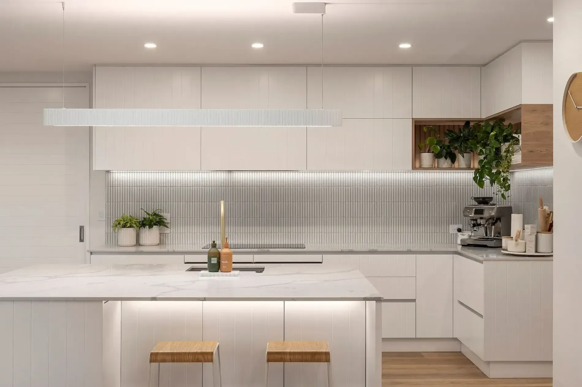 An artist 's impression of a kitchen with white cabinets and a large island.