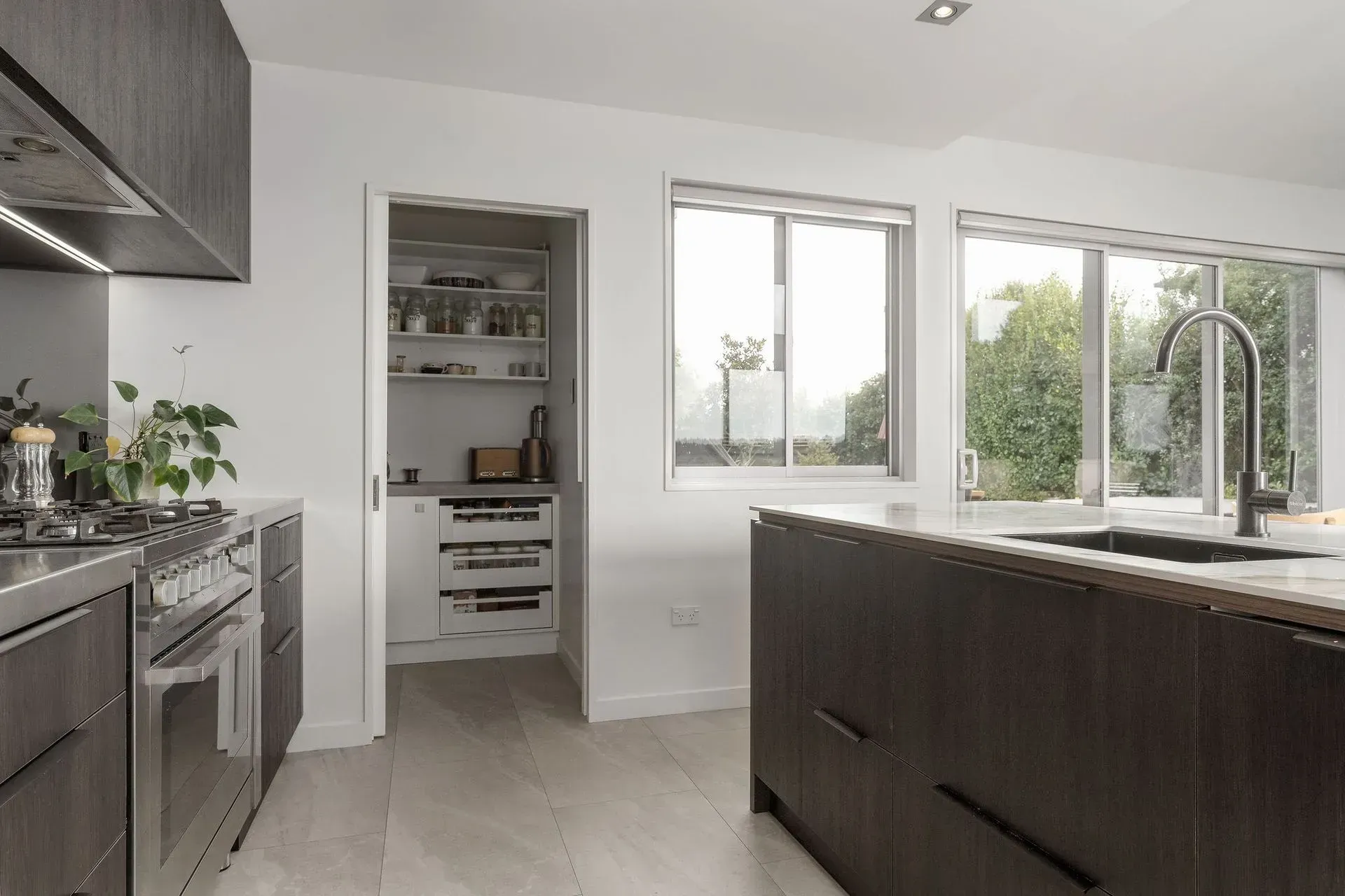 A kitchen with stainless steel appliances and wooden cabinets