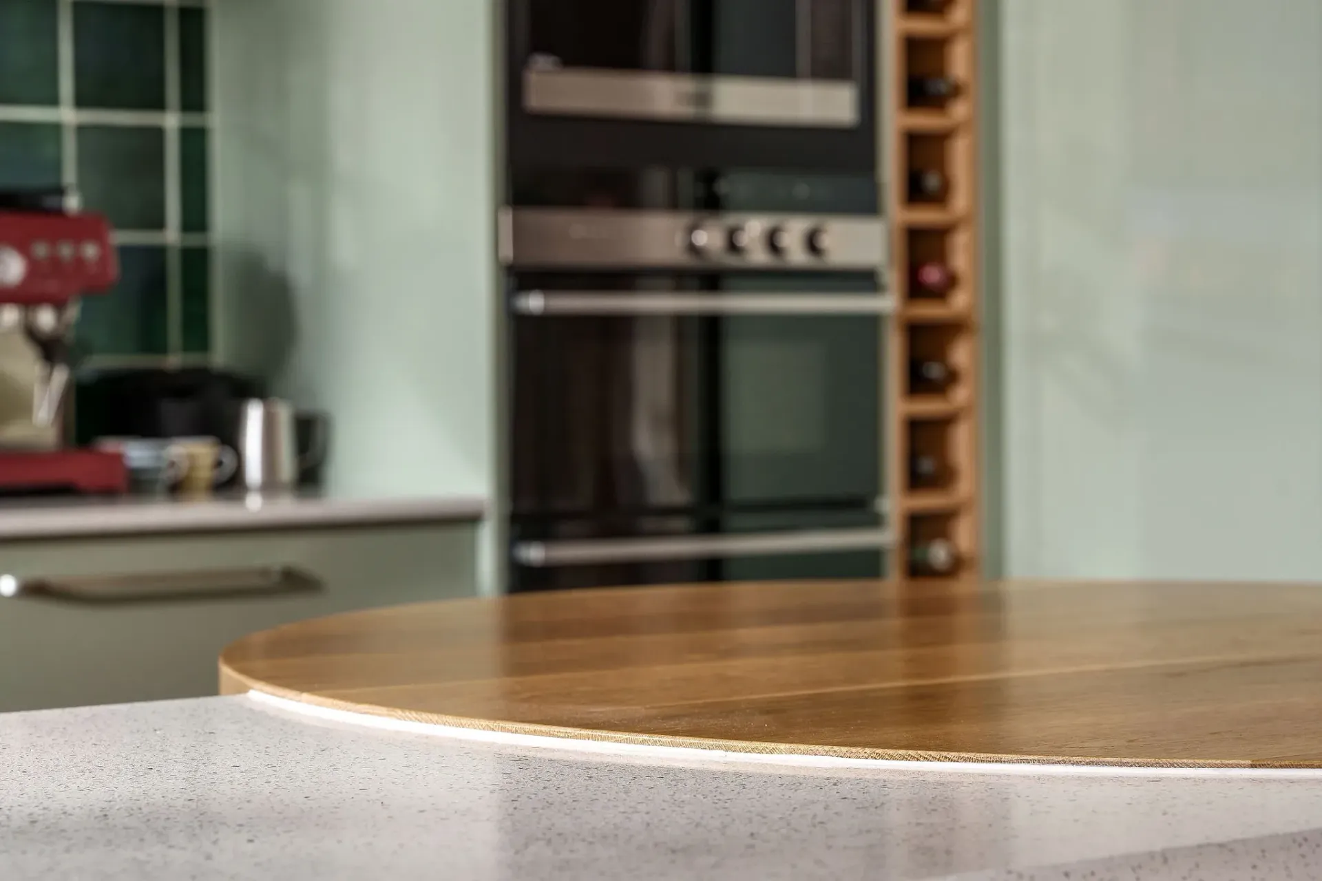 A wooden table is sitting on top of a counter in a kitchen.