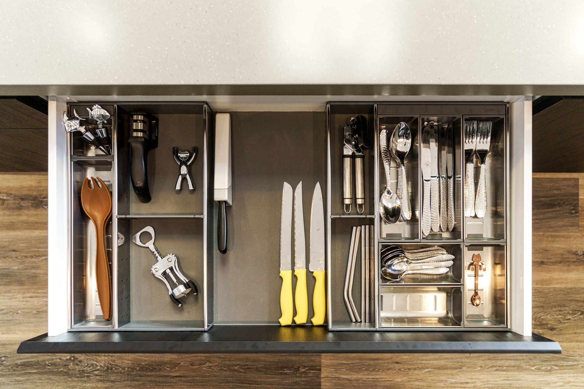 A kitchen drawer filled with knives and utensils