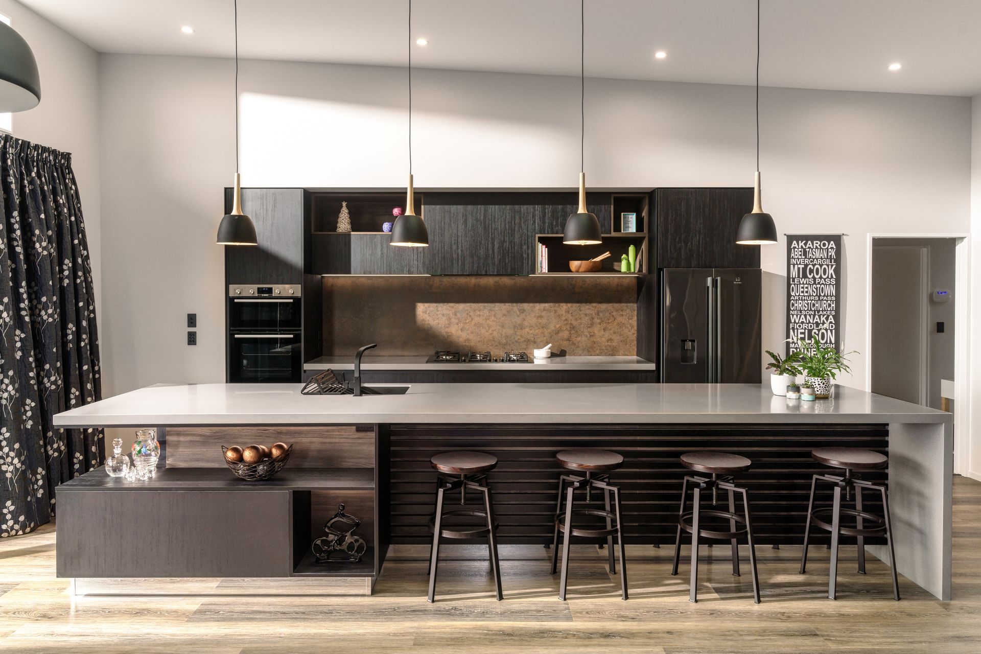 A kitchen with a large island and stools