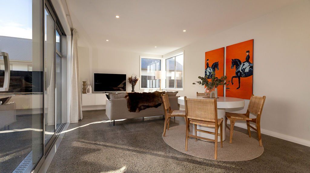 A living room with a couch a table and chairs
