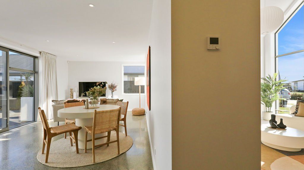 A living room with a table and chairs and a dining room with a table and chairs.