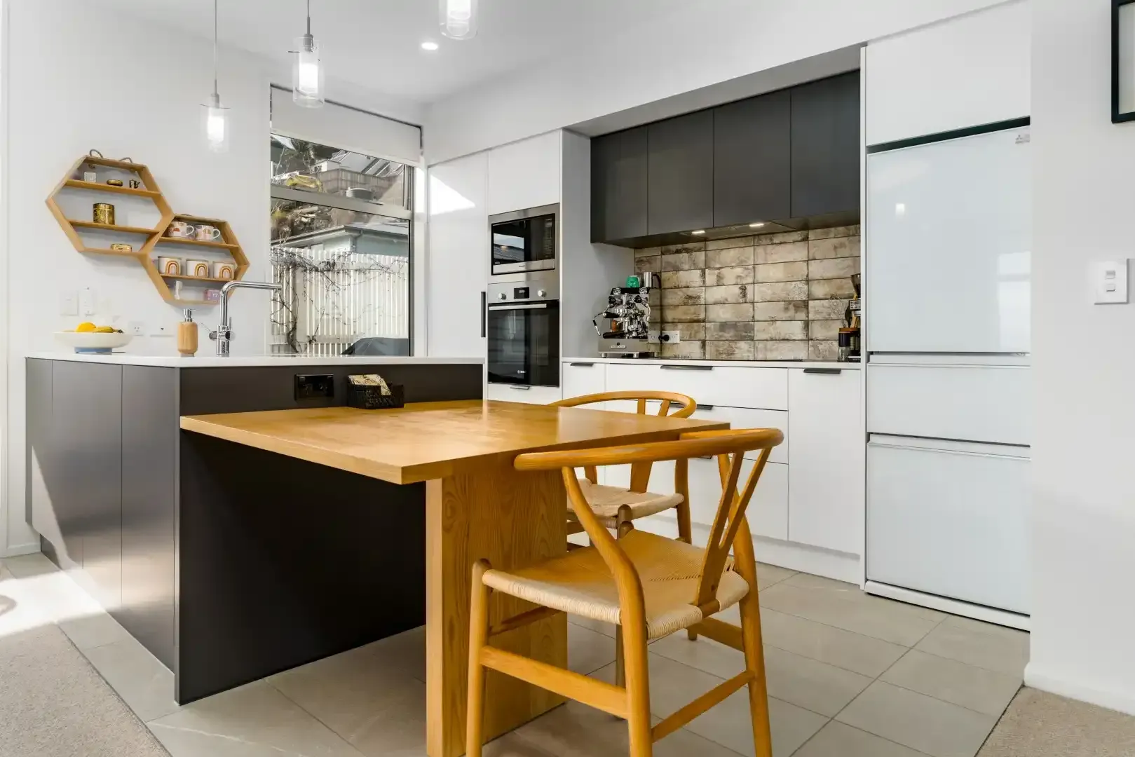 A kitchen with a table and chairs in it.