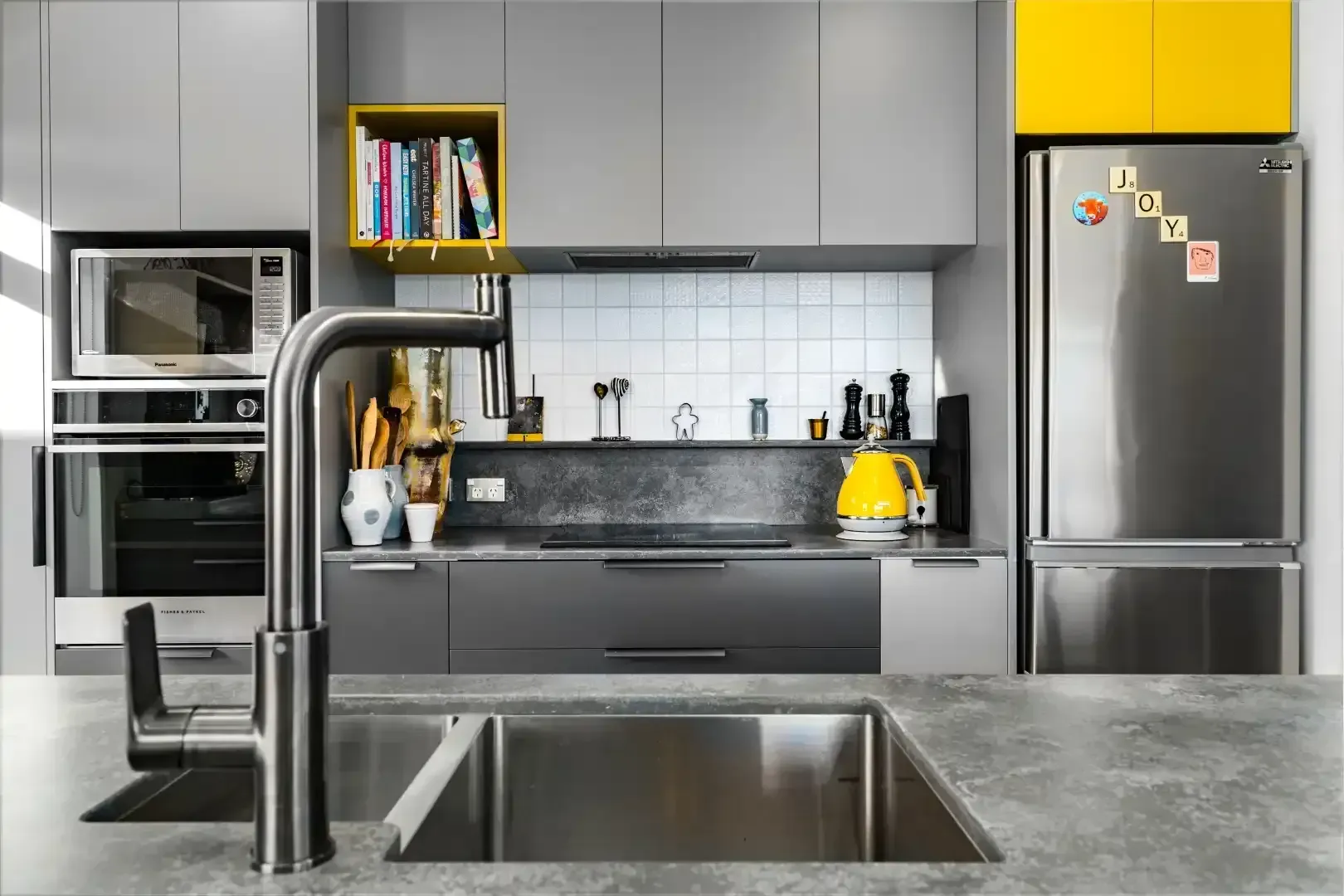 A kitchen with stainless steel appliances and a sink.