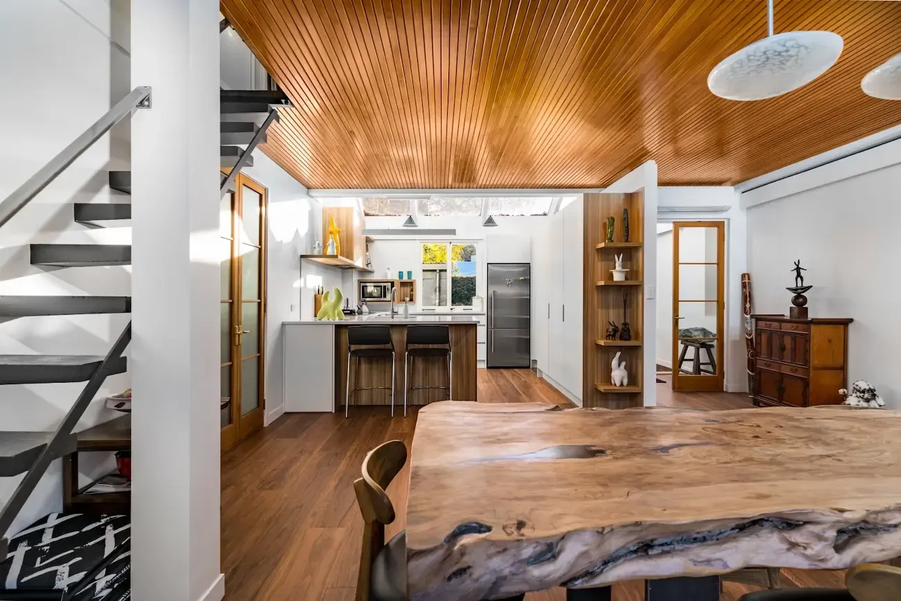 There is a large wooden table in the middle of the room.