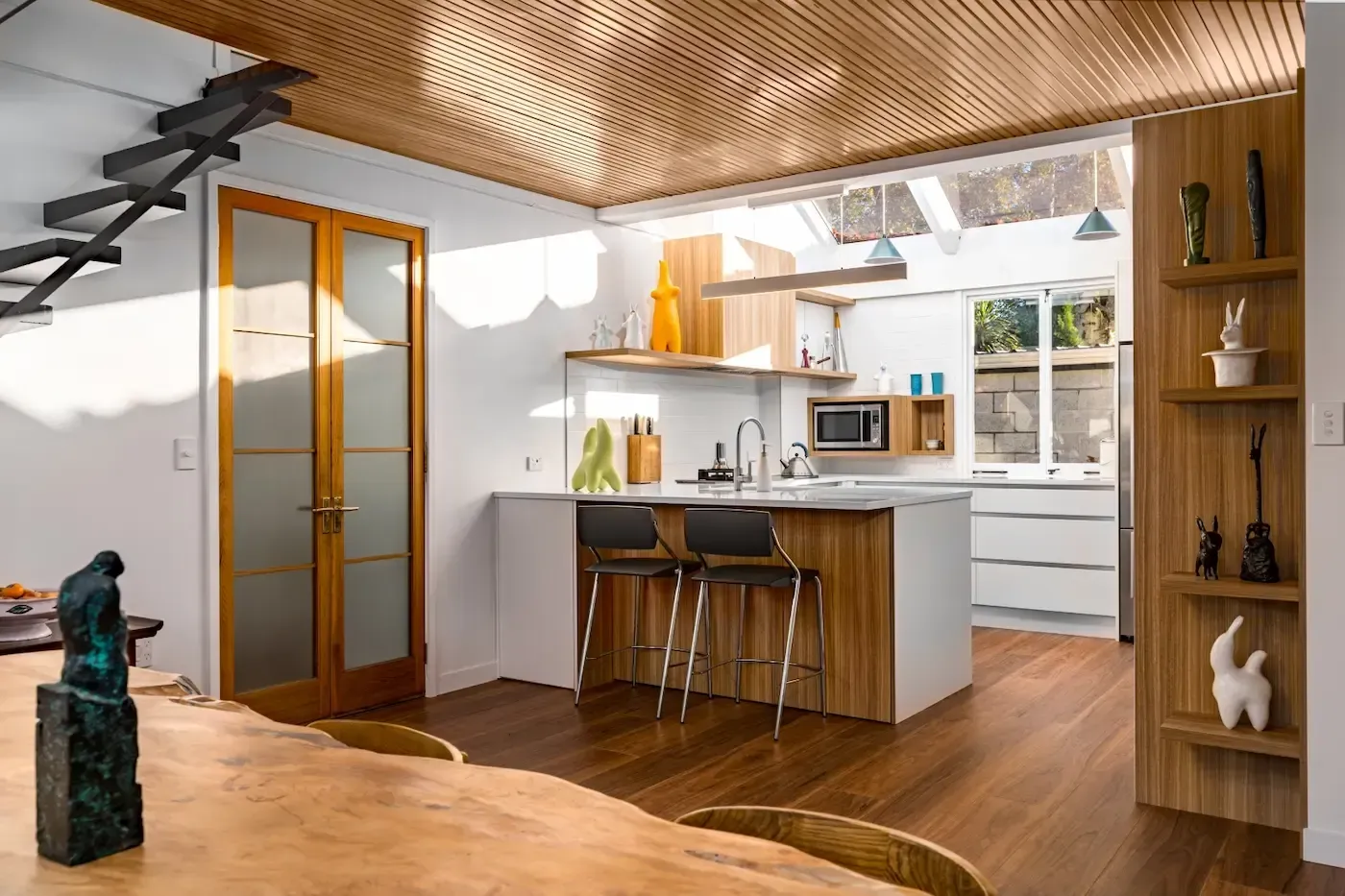 A kitchen with a table and chairs in it
