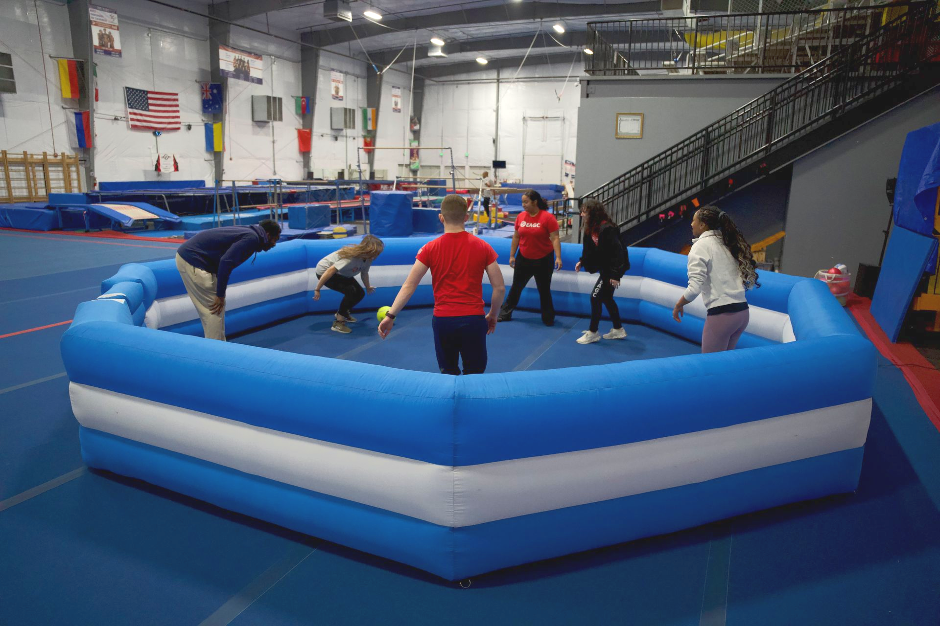 participants playing a game of gaga ball in the blowup gaga pit