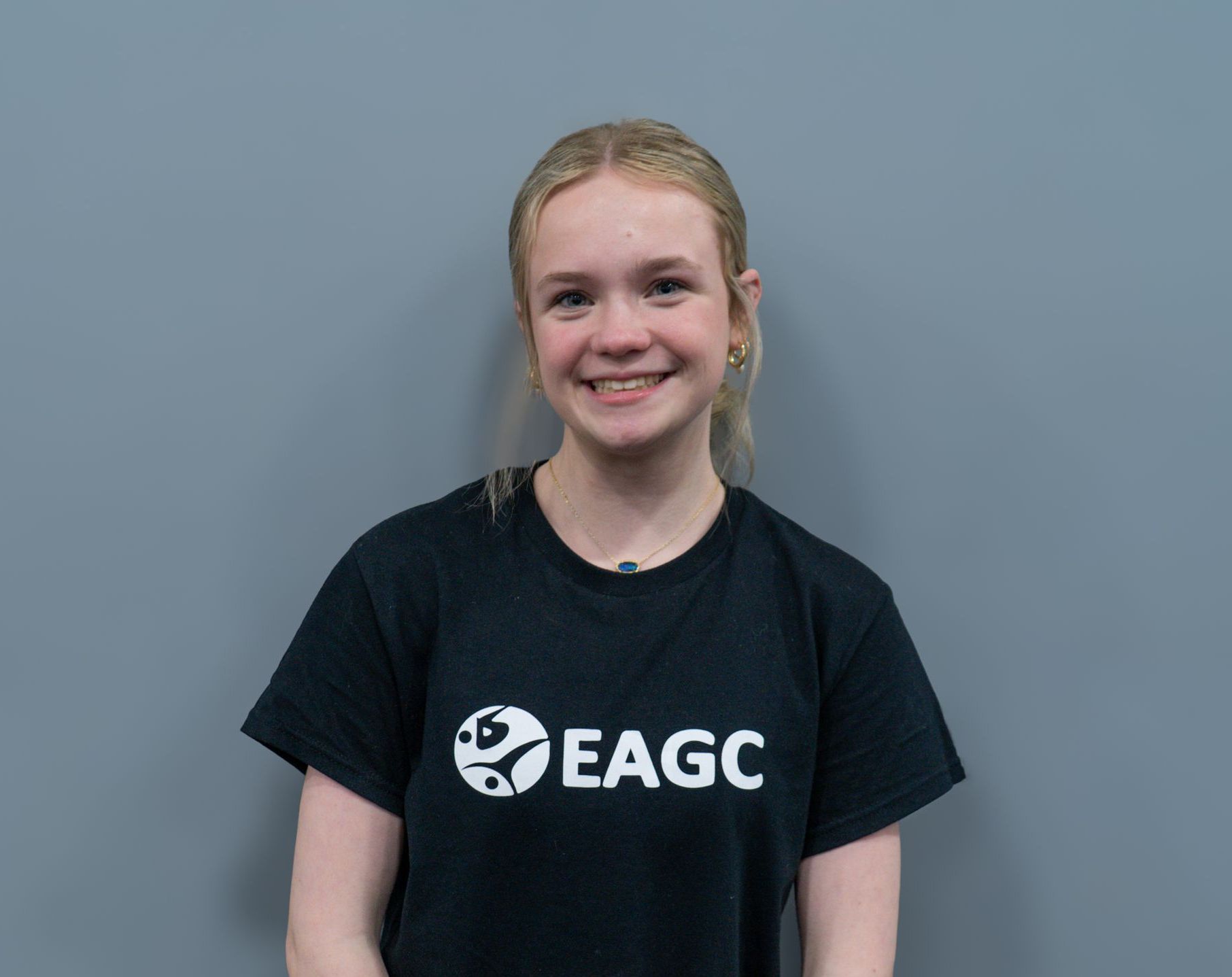 A Female Rec Coach wearing a black EAGC Tshirt