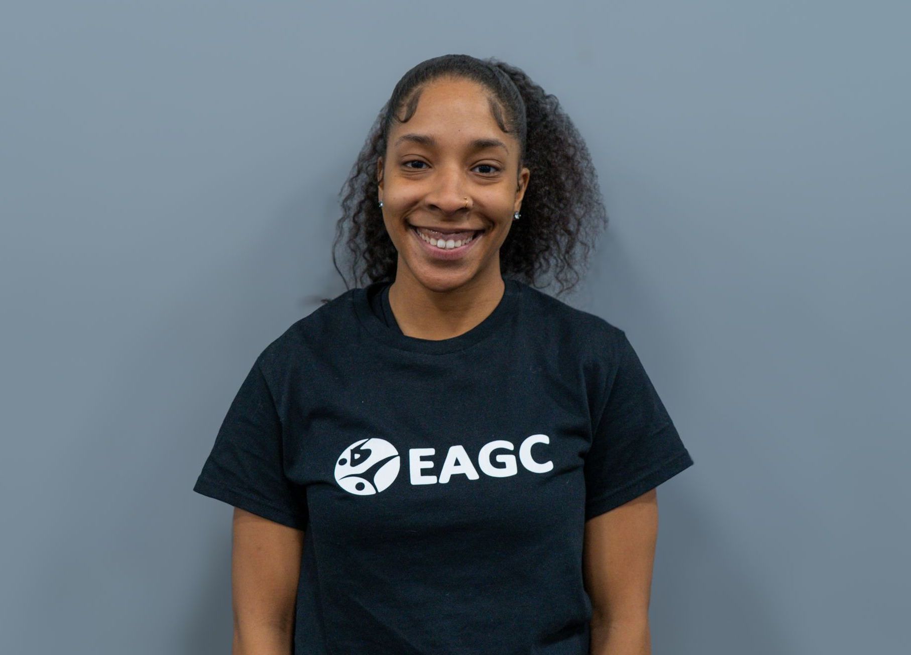 A Female Rec Coach wearing a black EAGC Tshirt