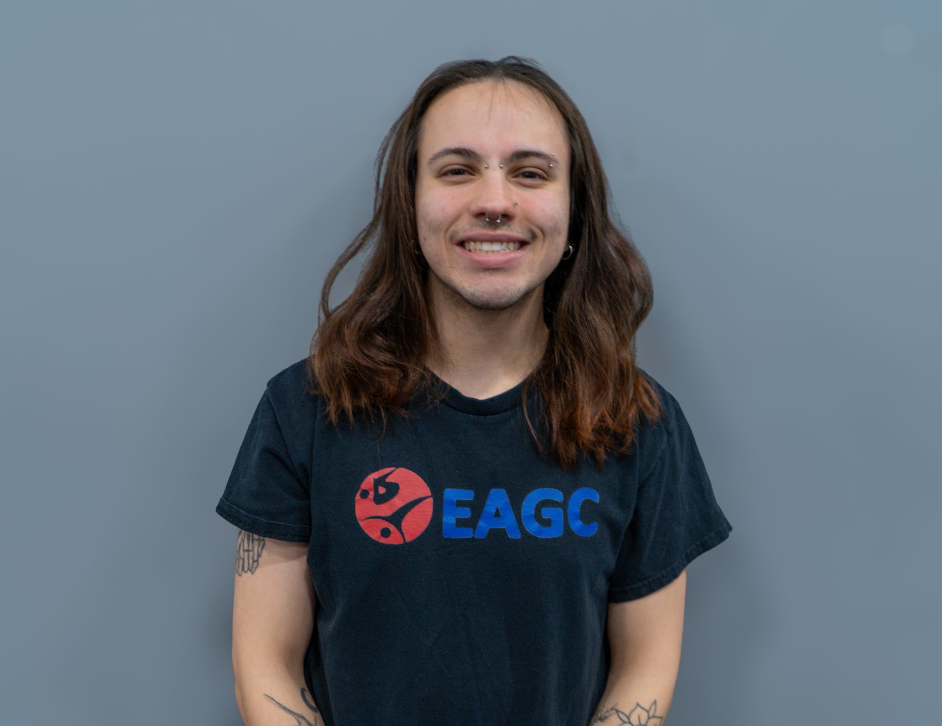 A woman in a black shirt is smiling for the camera.