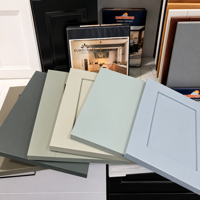 Paint color swatches fanned out in front of interior design sample boards and frames