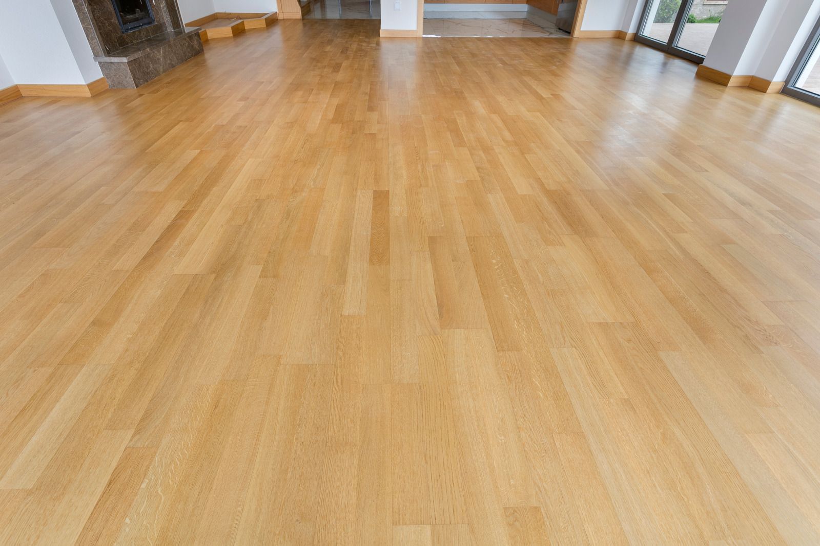Empty room with light wood flooring and white walls
