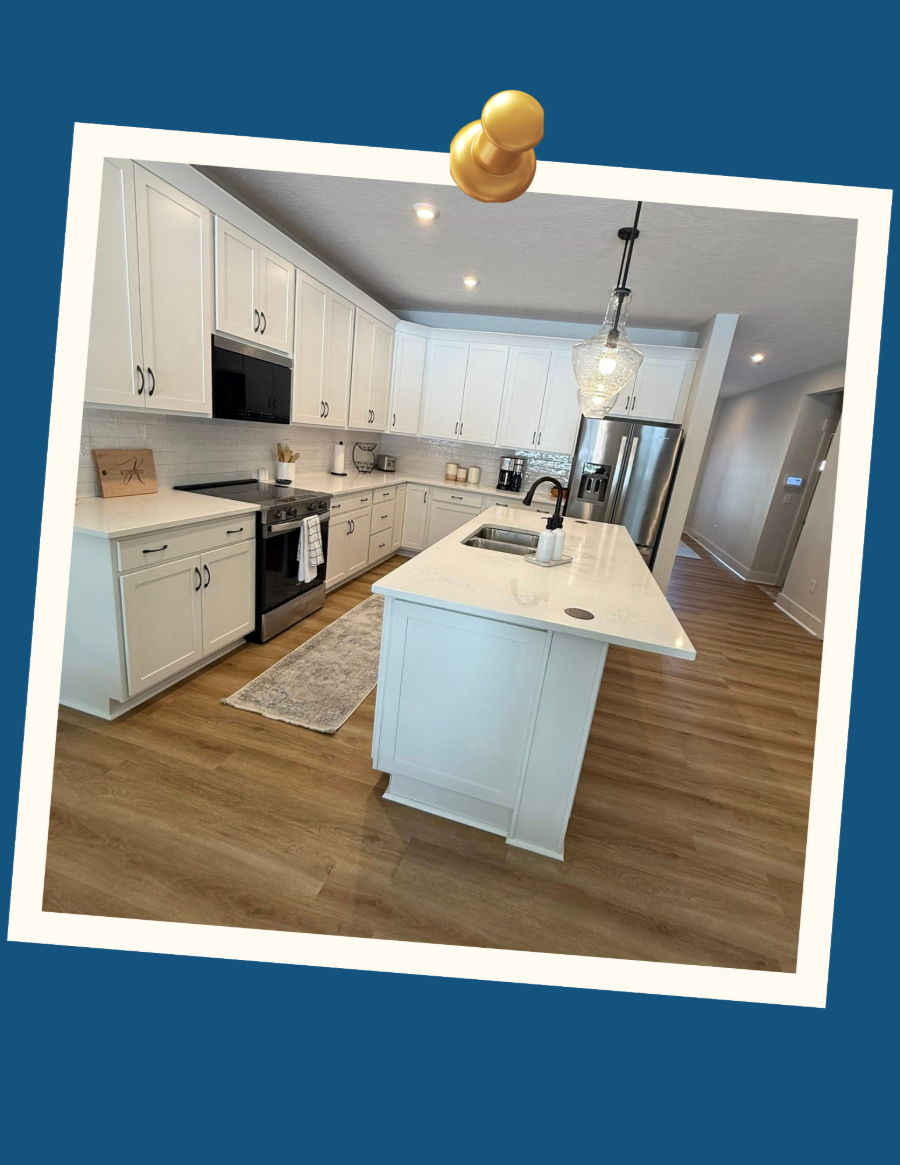 Bright white modern kitchen with island, wood floors, and blue wall border